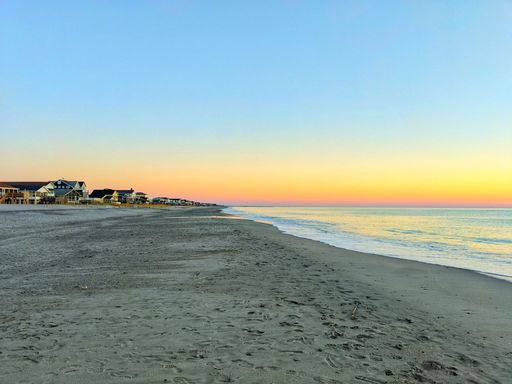A beautiful view of seashore with buildings background during sunset