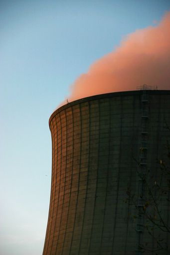 A vertical shot of smoke coming out from a power plant chimney