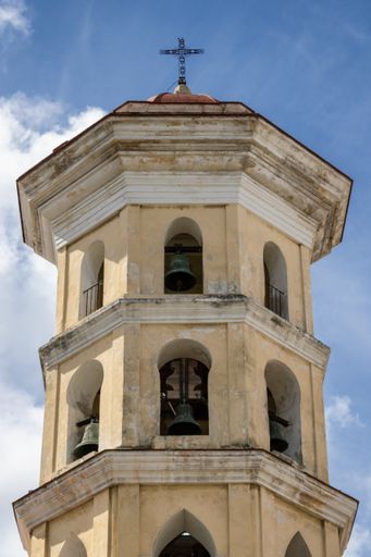 A closeup shot of an old church dome with a cross on the top, architecture of Havana, Cuba
