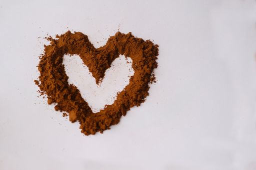 A heart shape created with coffee on the white background