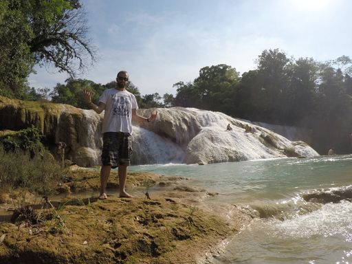 A beautiful shot of a male posing for the camera near the Agua Azil waterfalls in Mexico