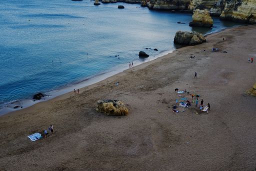 An aerial view of people on a sandy beach