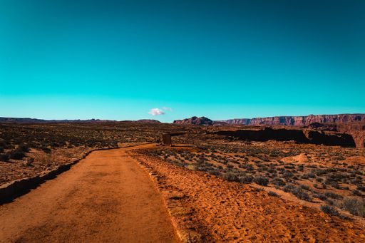 A Mesmerizing scene of canyon rocky ground with wild grass against a cloudy sky in Arizona, USA