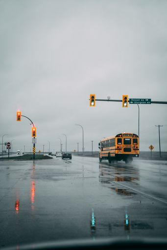 A bus in the street in a rainy evening