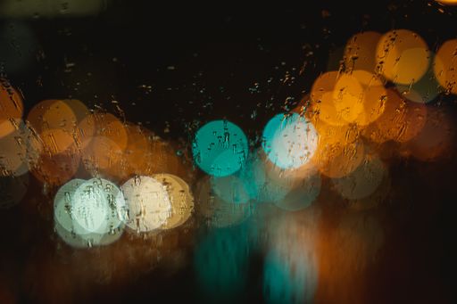 An abstract blur background of a rainy city at night