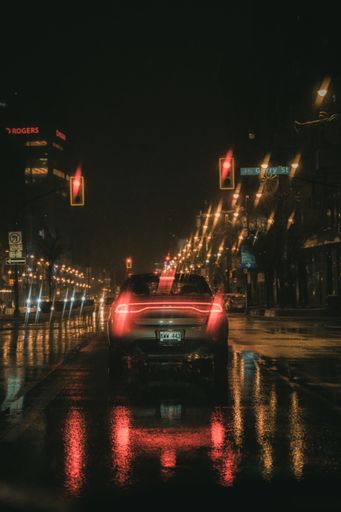 A blurred shot of cars in the street at rainy night