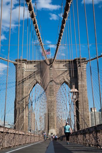 A vertical low angle shot of the Brooklyn Bridge in New York, USA