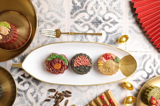 A top view of small moon cakes served for Chinese ceremony on the white plate with golden edges