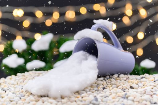 A Closeup of Christmas gifts and decorations with a  snowy background and bokeh lights