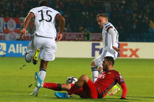 A tackling between players during a Soccer match at FIFA World Cup group stage qualification match Armenia VS Germany in Yerevan, Armenia