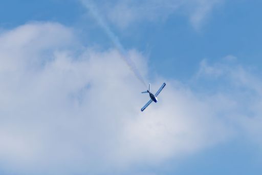 SubSonex JSX2 jet captured in a downward maneuver leaving a faint smoke trail against a bright sky at the 2025 Stuart Airshow.