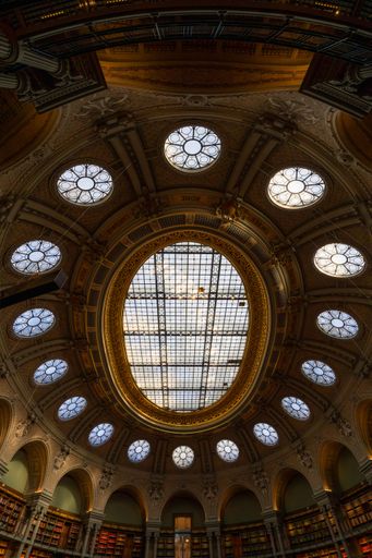 Stunning interior view of a historical library dome with intricate stained glass and architectural details.