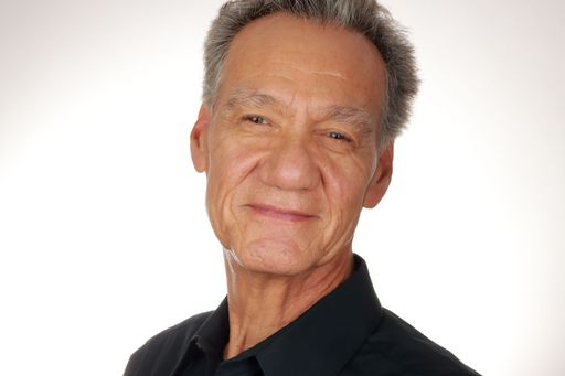 Portrait of an Older Man wearing a black shirt on a white background