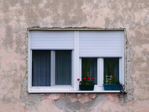 The windows decorated with flowers outside on a windowsill