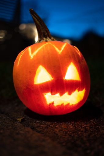 A vertical closeup shot of a Halloween jack o' lantern
