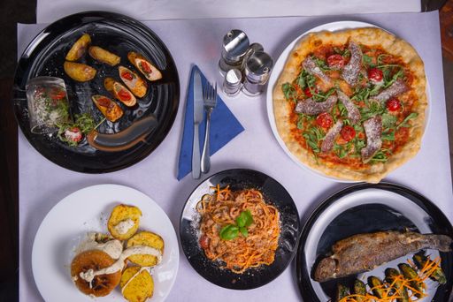 A top view of different dishes on a white table