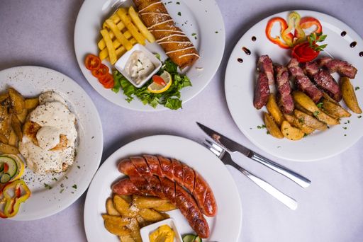 A top view of different dishes on a white table