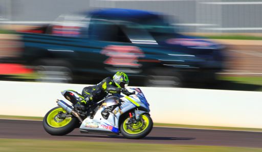 A selective focus shot of a man riding his motorcycle at high speed in Johannesburg, South Africa