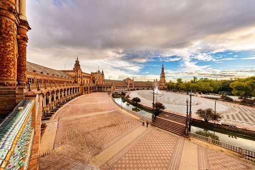 Plaza de Espana in Seville, Spain, with stunning architecture under a dramatic sky