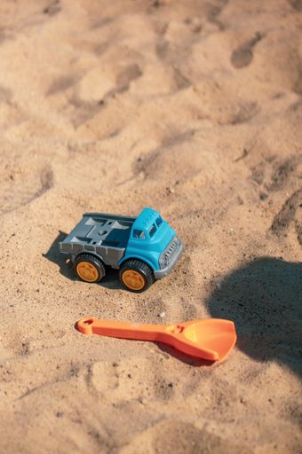A closeup shot of small plastic toys on the sand