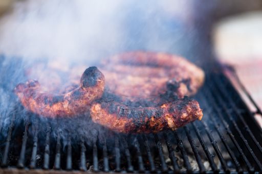 A closeup shot of cooking sausages on a barbecue grill