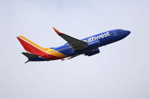 The side view of Southwest Airlines Boeing 737-700 taking off from San Jose International Airport on a cloudy morning, heading to San Diego