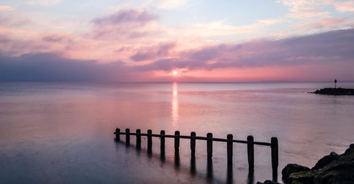 A beautiful shot of a colorful magnificent over the sea with calm waves
