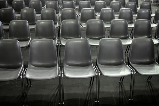 The gray empty audience seats arranged in rows
