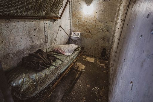 A high angle shot of an old abandoned jail cell room