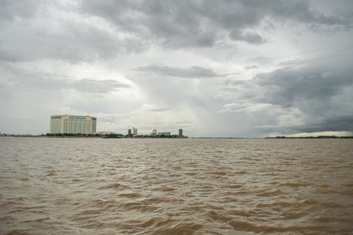 A luxury hotel, built on the river bank at the confluence conflux of Tonle Sap River and Mekong River in Phnom Penh, Cambodia, South East Asia monsoon
