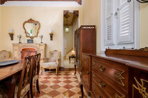The details from a dining room with woodwork furniture in a classic home interior in Havana, Cuba