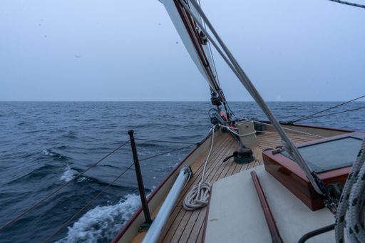 A board of a sailing boat in the wavy sea under a clear sky, Maine, USA