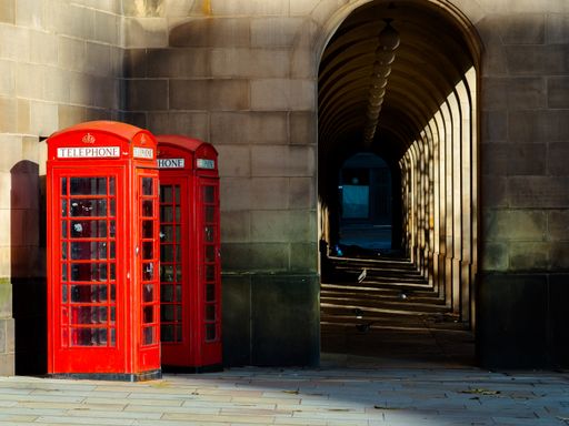 A view of two red telephone boxes in the city of Great Britain