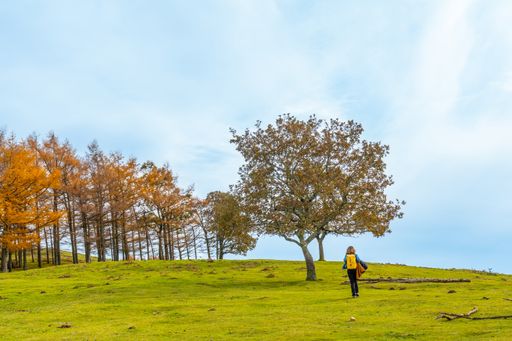 A young woman walking on the top of Mount Erlaitz in the town of Irun in Basque Country