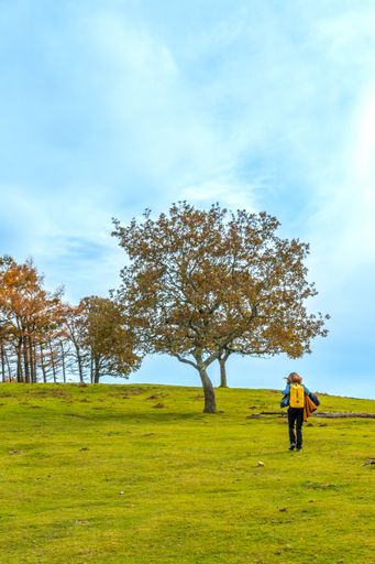 A young woman walking on the top of Mount Erlaitz in the town of Irun in Basque Country