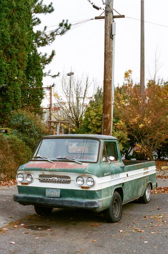 A vertical shot of a vintage green and white Chevrolet pickup truck