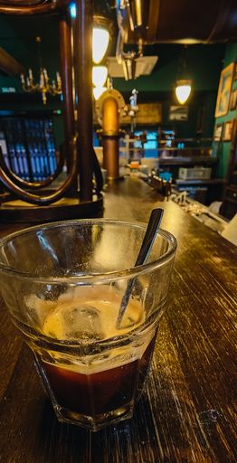 A vertical shot of ice coffee in a glass.