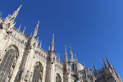 A top view of the Milan Cathedral against a blue sky on a sunny day in Ital