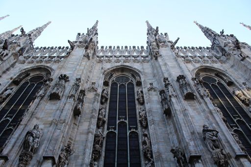 A top view of the Milan Cathedral against a light blue sky on a sunny day in Italy