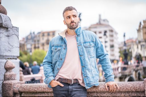 A young Caucasian man in a photoshoot in the city of San Sebastian