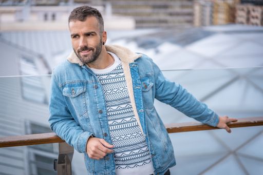 A young caucasian man wearing a jeans coat in San Sebastian