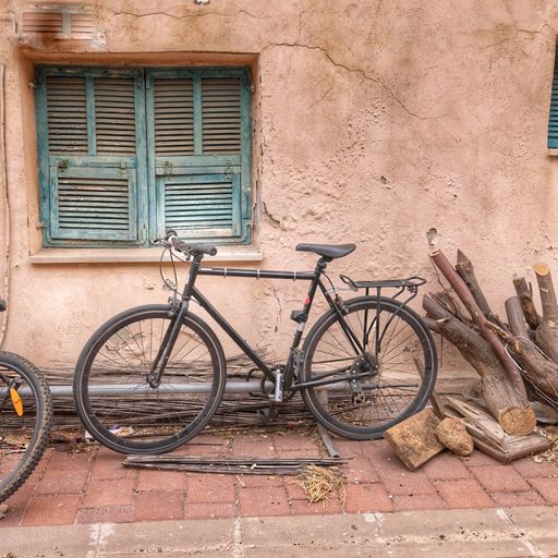 A close-up shot of an old Soviet bike on the pink background