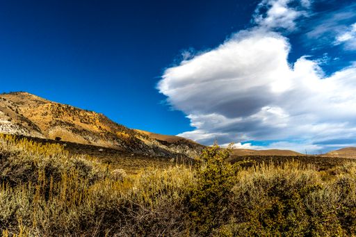 The storm clouds over the dry fields on a sunny day near Mono Lake in California