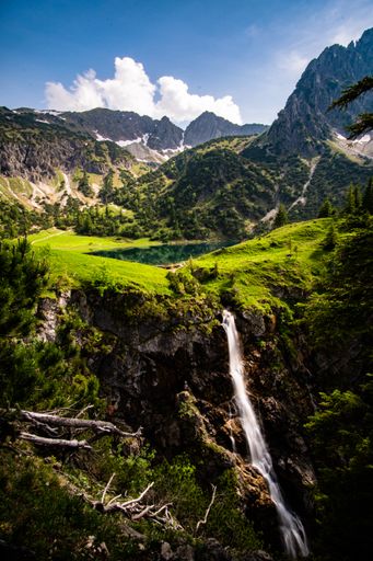 A mesmerizing scene of landscapes of green mountains with a blue sky in Allgauer Hochalpen Oberstdorf, Germany