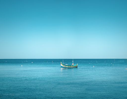 A mesmerizing shot of a boat in the middle of a sea under the crystal-clear skies