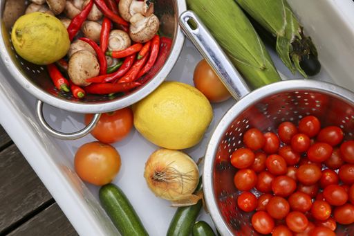 Washing, disinfecting, rinsing and drying food after it has been purchased from a supermarket. Coronavirus (covid-19) prevention concept image.