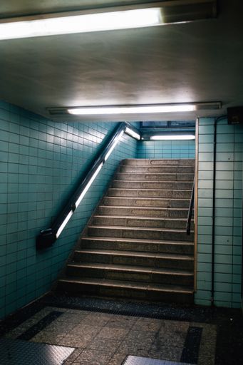 A vertical shot of stairs in a subway corrido