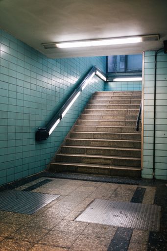 A vertical shot of a staircase of an underground metro station