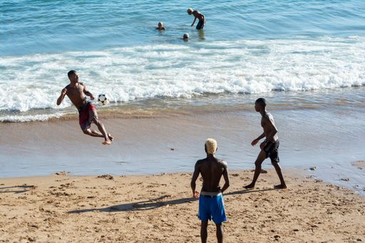 A group of Young people playing sand football at sunset on Ondina beach in Salvador, Bahia, Brazil