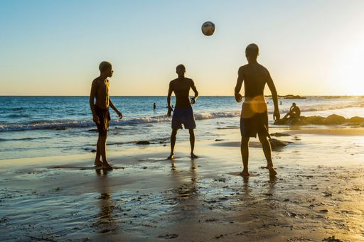 A group of Young people playing sand football at sunset on Ondina beach in Salvador, Bahia, Brazil